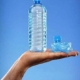 close up of man holding full plastic water bottle 28243